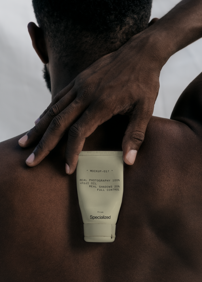 Photo of a lotion tube mockup held by a person over shoulder, realistic texture, professional design asset for branding presentations.